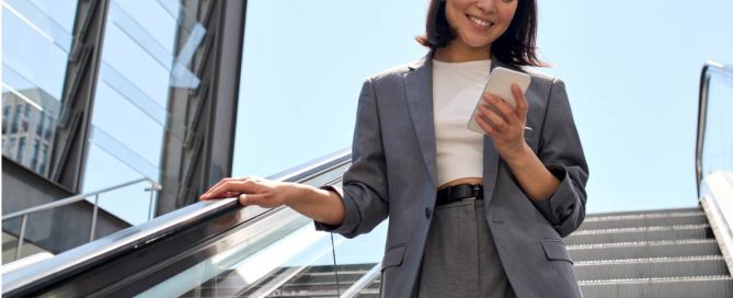 young business woman looking at phone